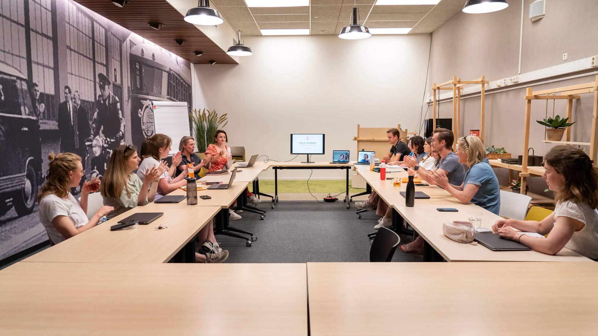 Connect teammeeting in Eindhoven. Collega's zitten aan een grote ronde tafel.